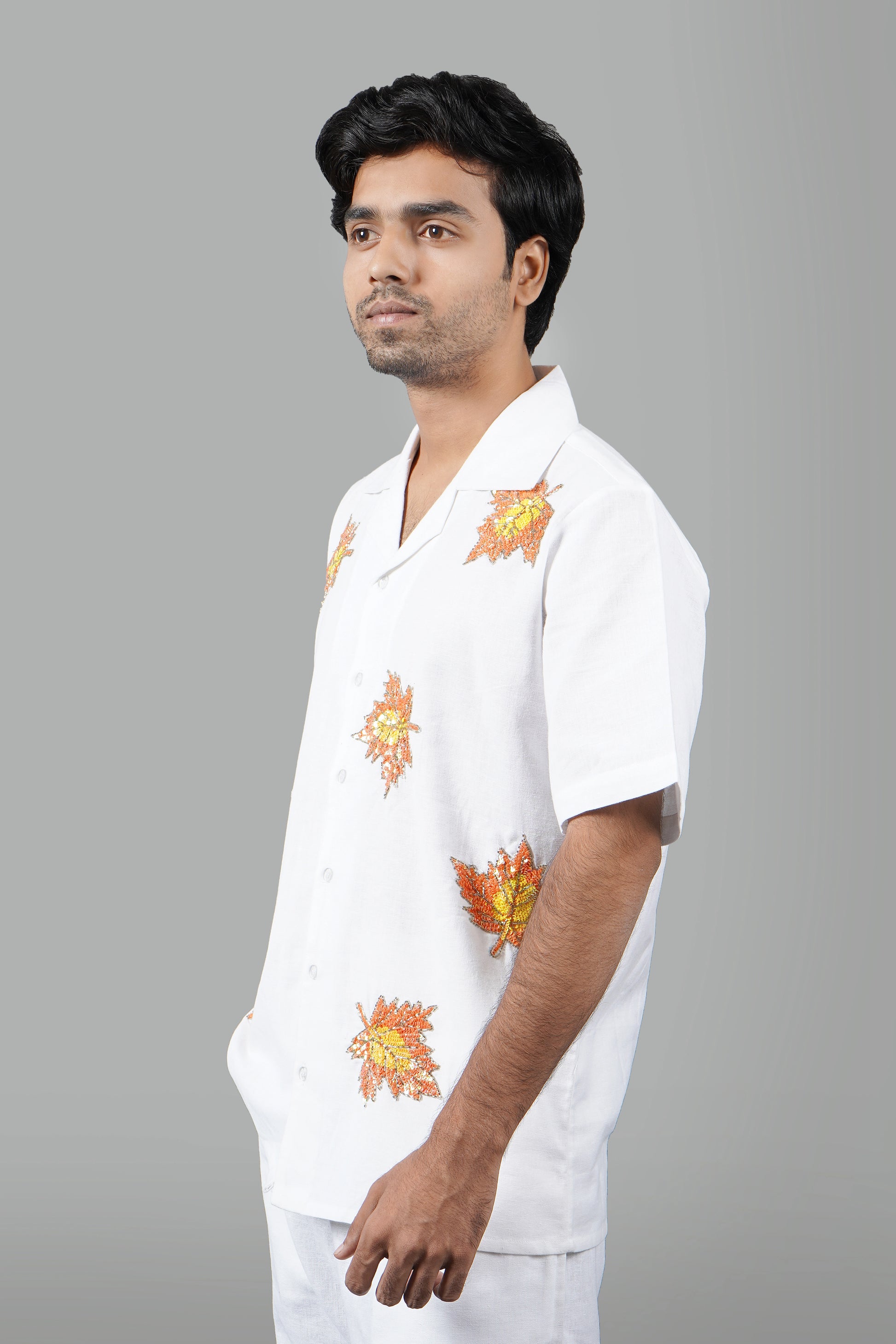 Handmade white linen blend shirt with maple leaf hand embroidery, premium embroidered casual wear for men, luxury artisanal shirt.

