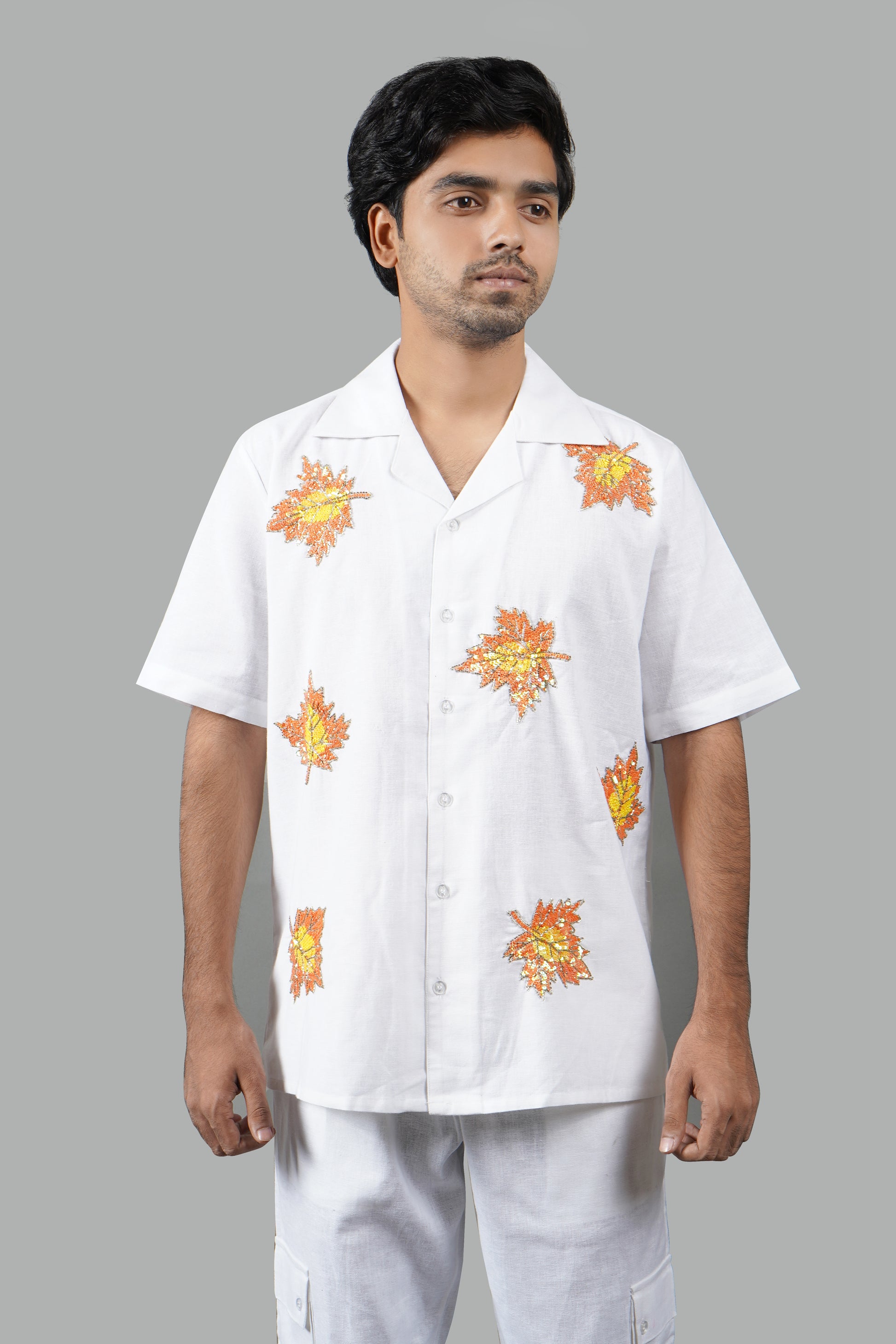 Handmade white linen blend shirt with maple leaf hand embroidery, premium embroidered casual wear for men, luxury artisanal shirt.

