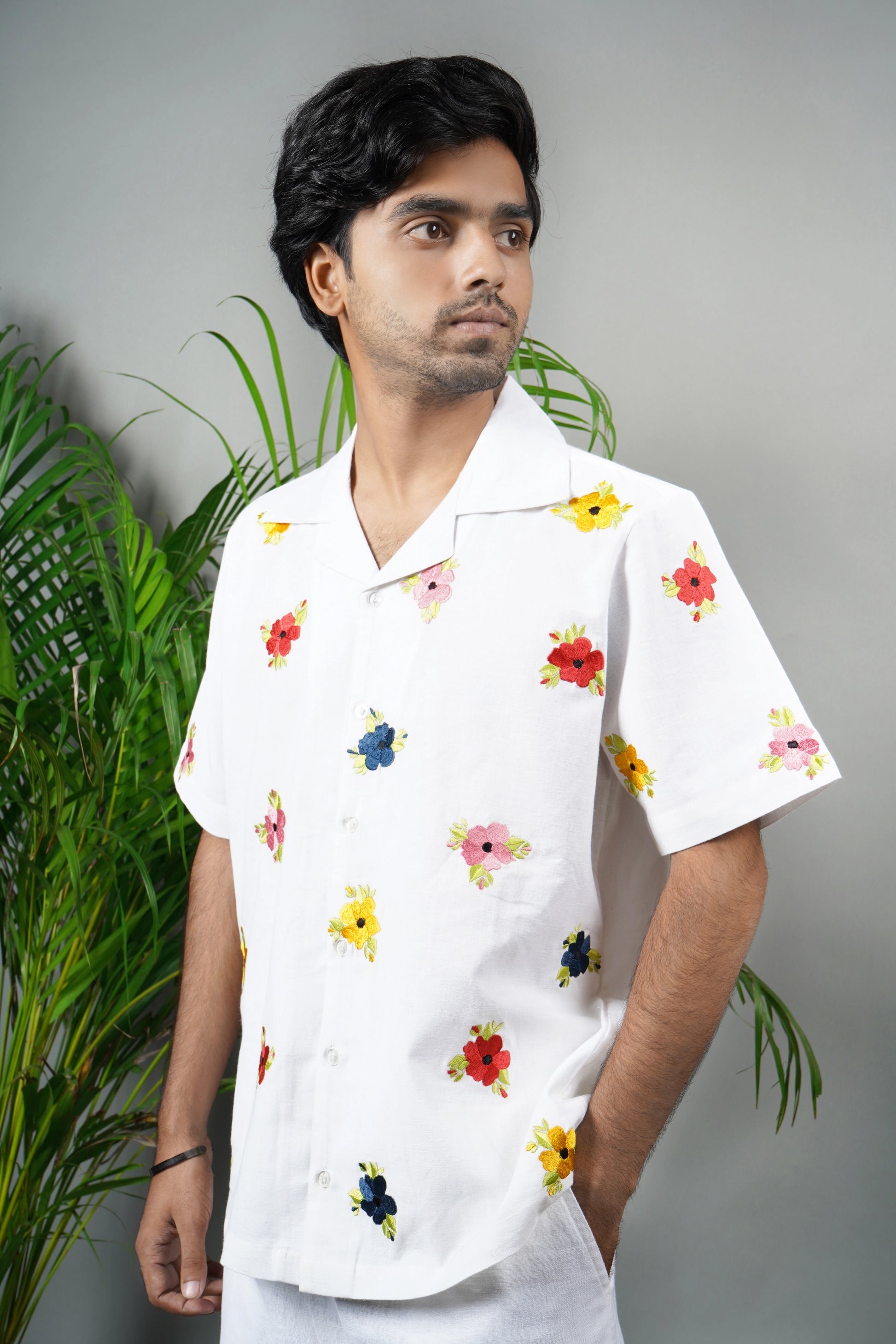  "White linen blend Cuban collar shirt for men, vibrant hand-embroidered floral design, lightweight and stylish summer essential.