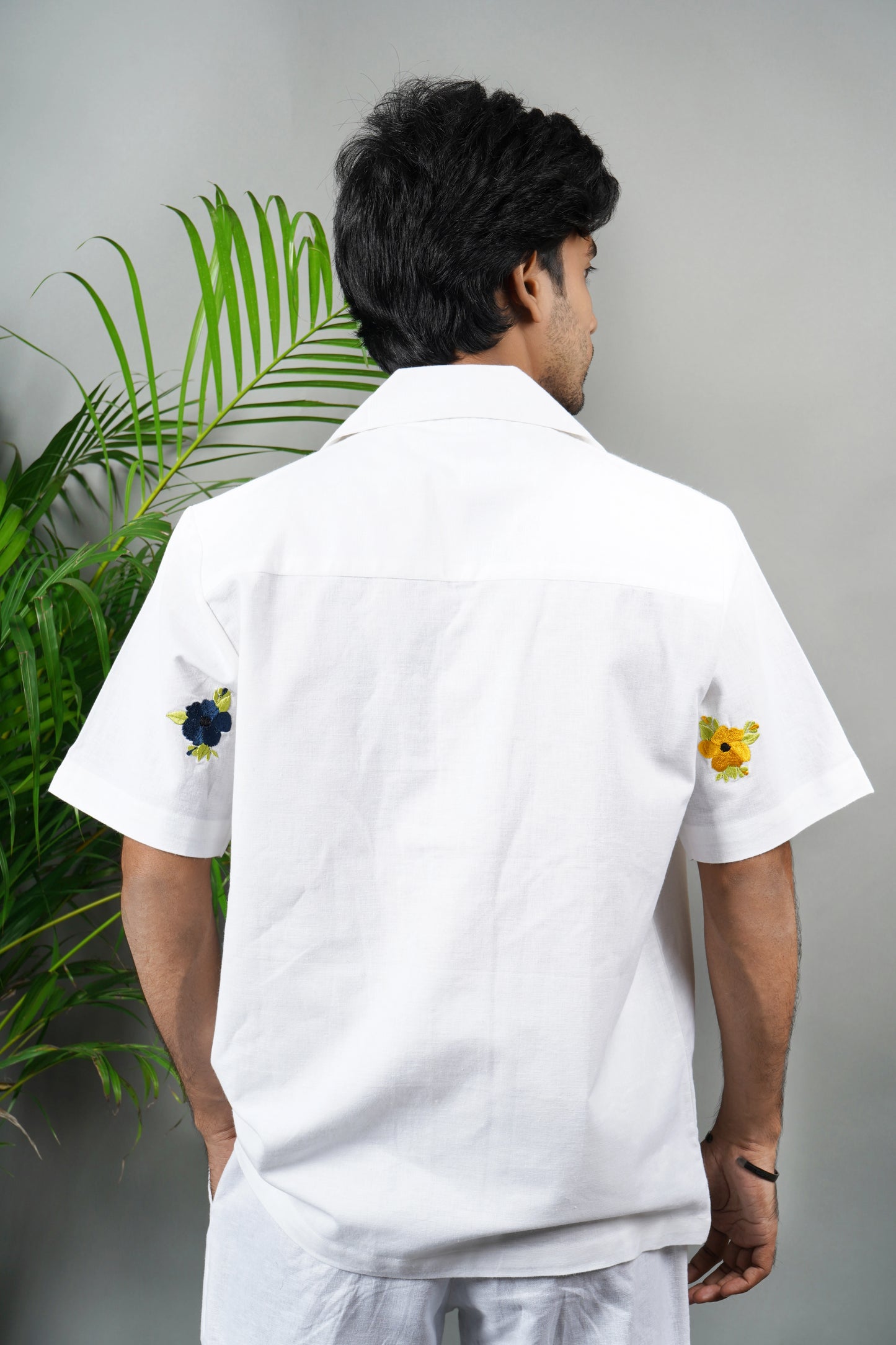  "White linen blend Cuban collar shirt for men, vibrant hand-embroidered floral design, lightweight and stylish summer essential.