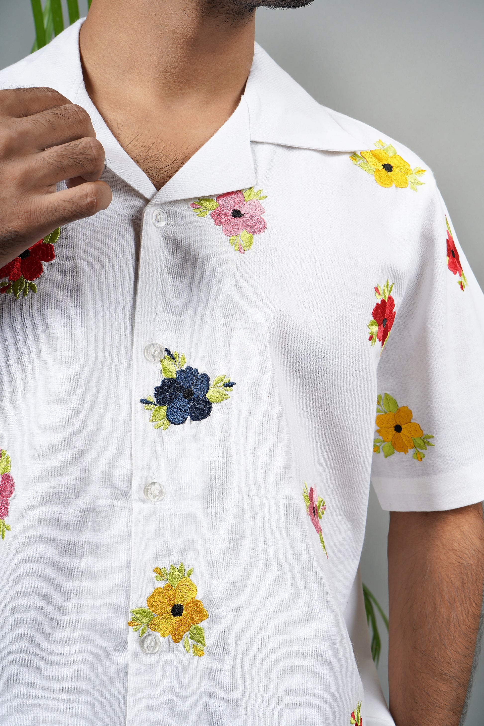  "White linen blend Cuban collar shirt for men, vibrant hand-embroidered floral design, lightweight and stylish summer essential.