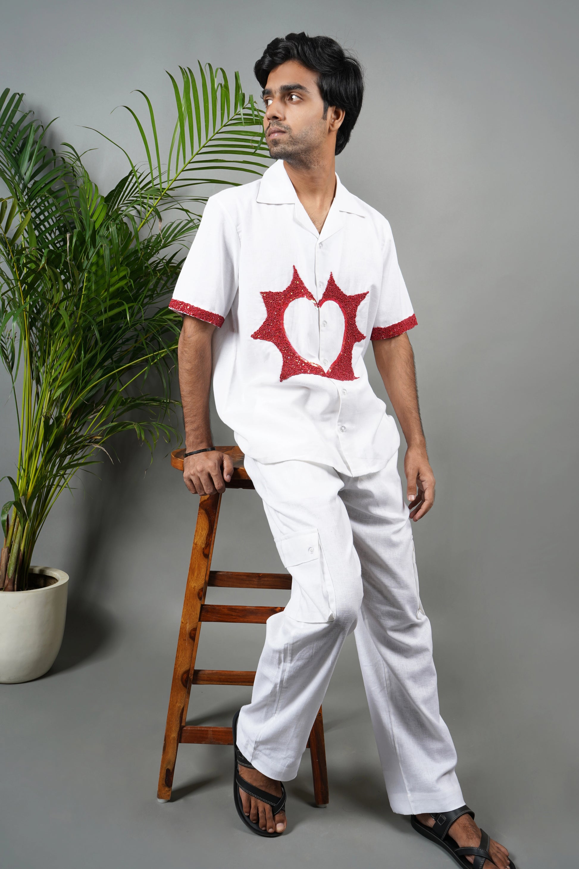 Handmade white linen blend shirt with bold red anatomical heart embroidery, unique hand-embroidered statement shirt, luxury fashion.

