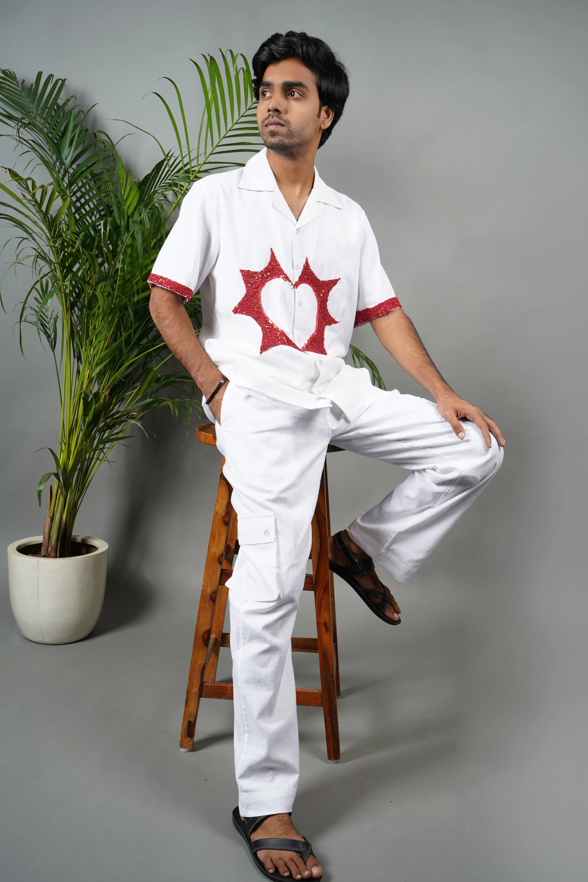 Handmade white linen blend shirt with bold red anatomical heart embroidery, unique hand-embroidered statement shirt, luxury fashion.

