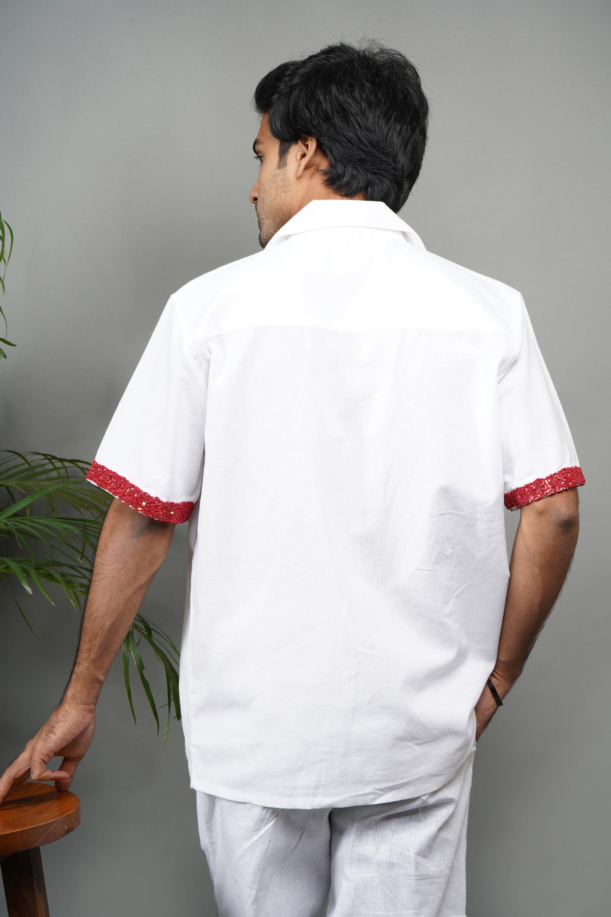 Handmade white linen blend shirt with bold red anatomical heart embroidery, unique hand-embroidered statement shirt, luxury fashion.

