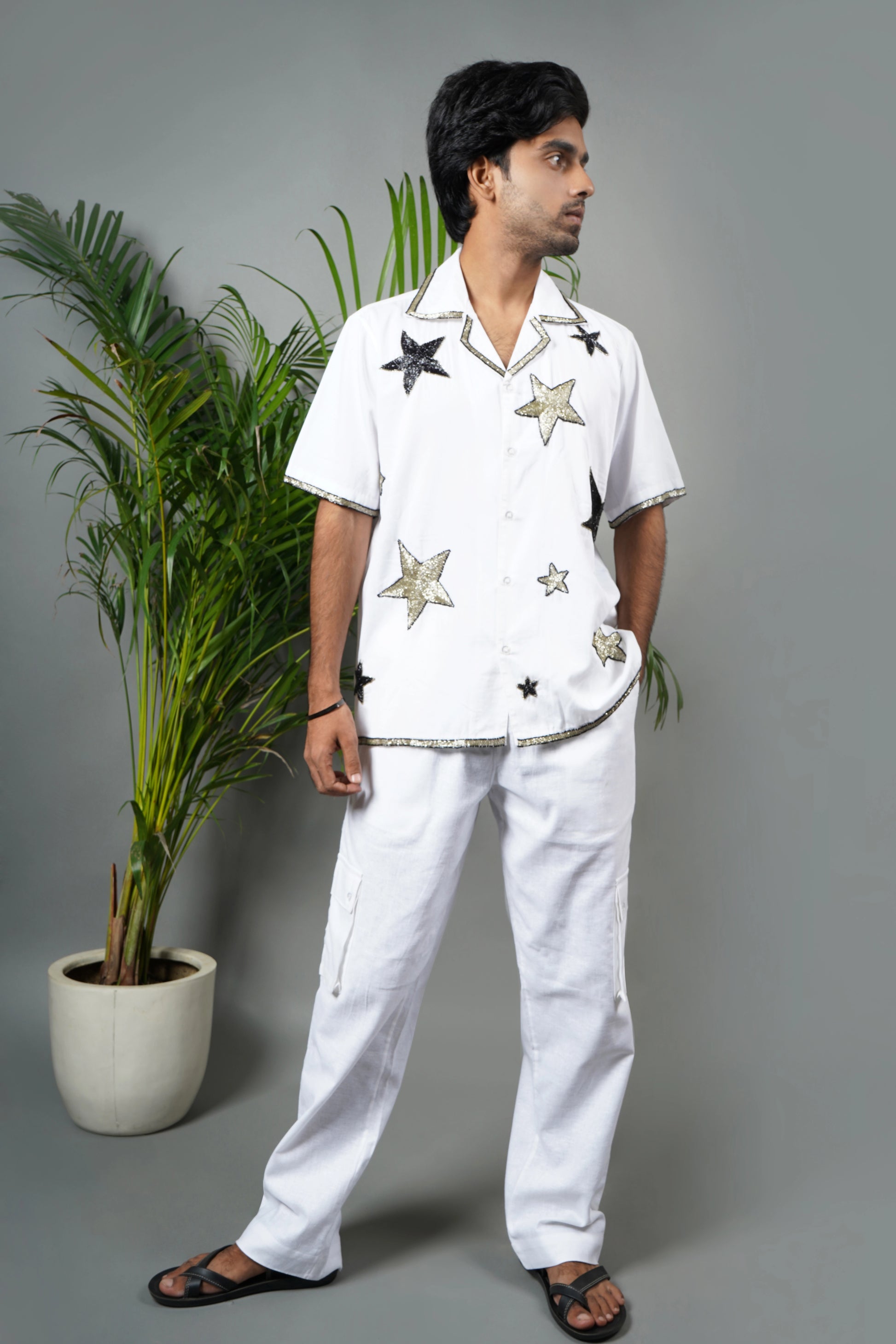 Handmade white cotton shirt with bold star pattern hand embroidery, premium embroidered men's fashion, luxury summer statement wear.

