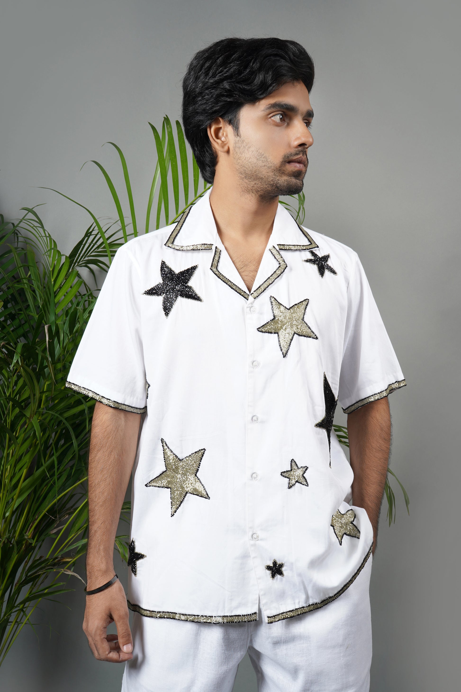 Handmade white cotton shirt with bold star pattern hand embroidery, premium embroidered men's fashion, luxury summer statement wear.

