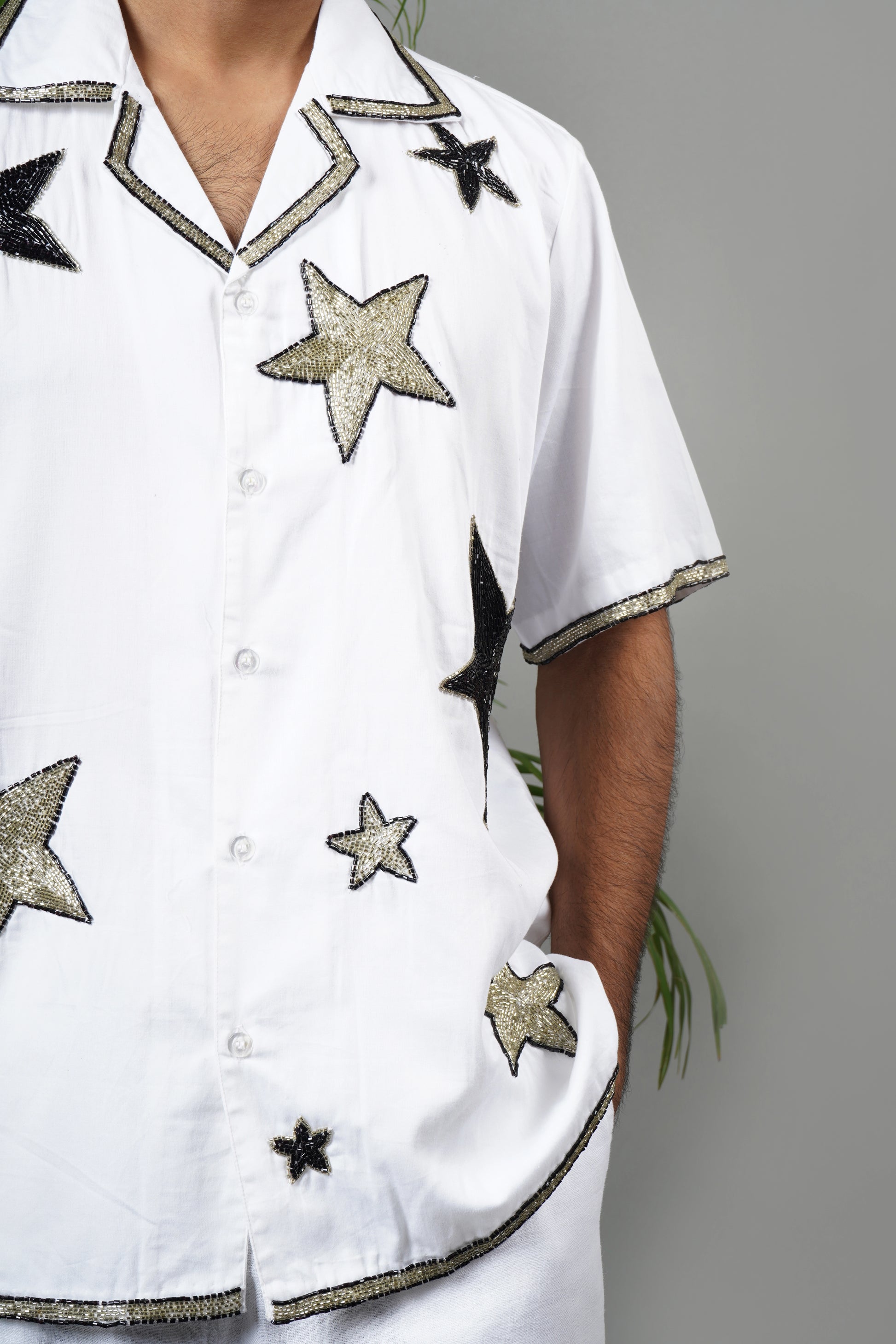 Handmade white cotton shirt with bold star pattern hand embroidery, premium embroidered men's fashion, luxury summer statement wear.

