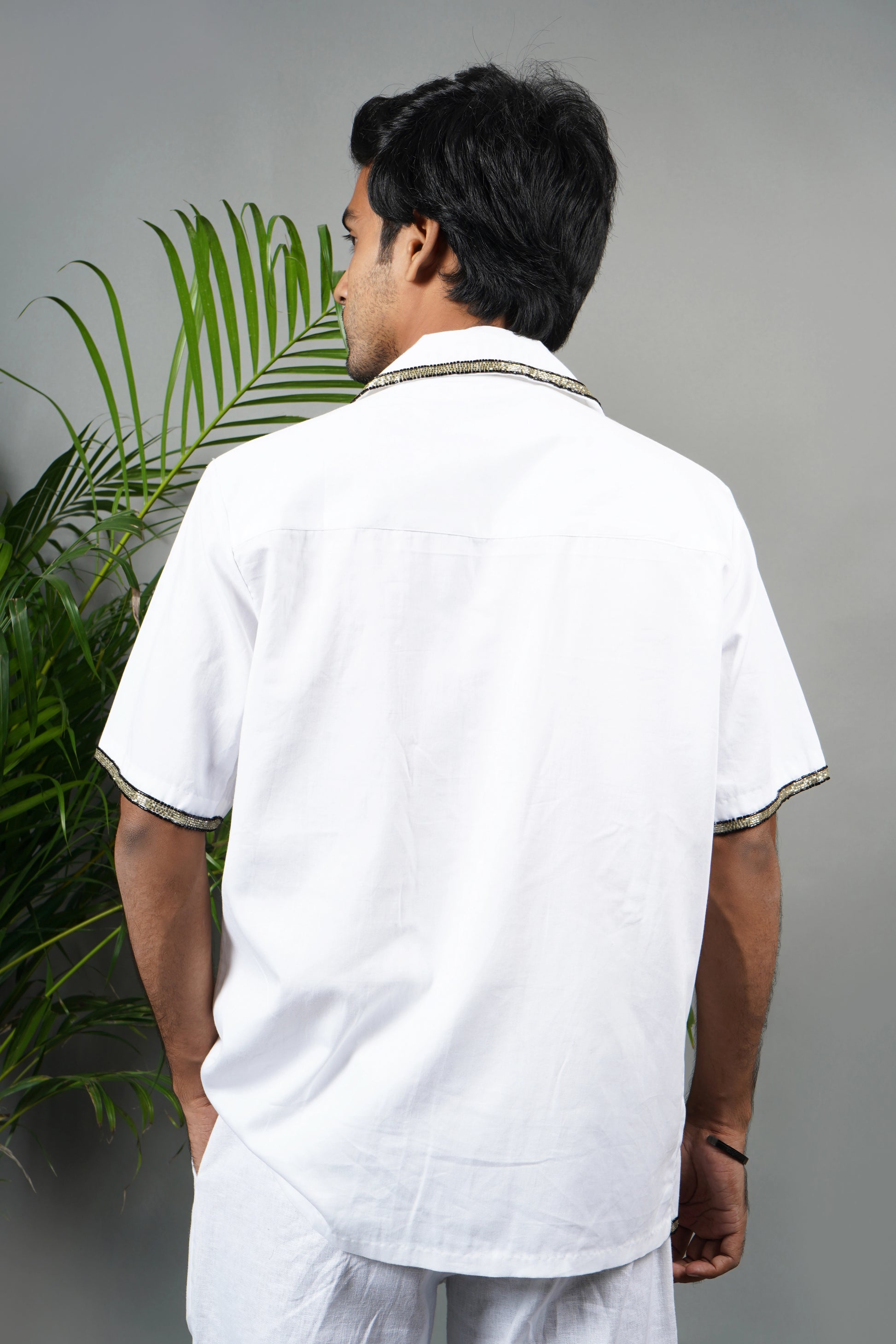 Handmade white cotton shirt with bold star pattern hand embroidery, premium embroidered men's fashion, luxury summer statement wear.

