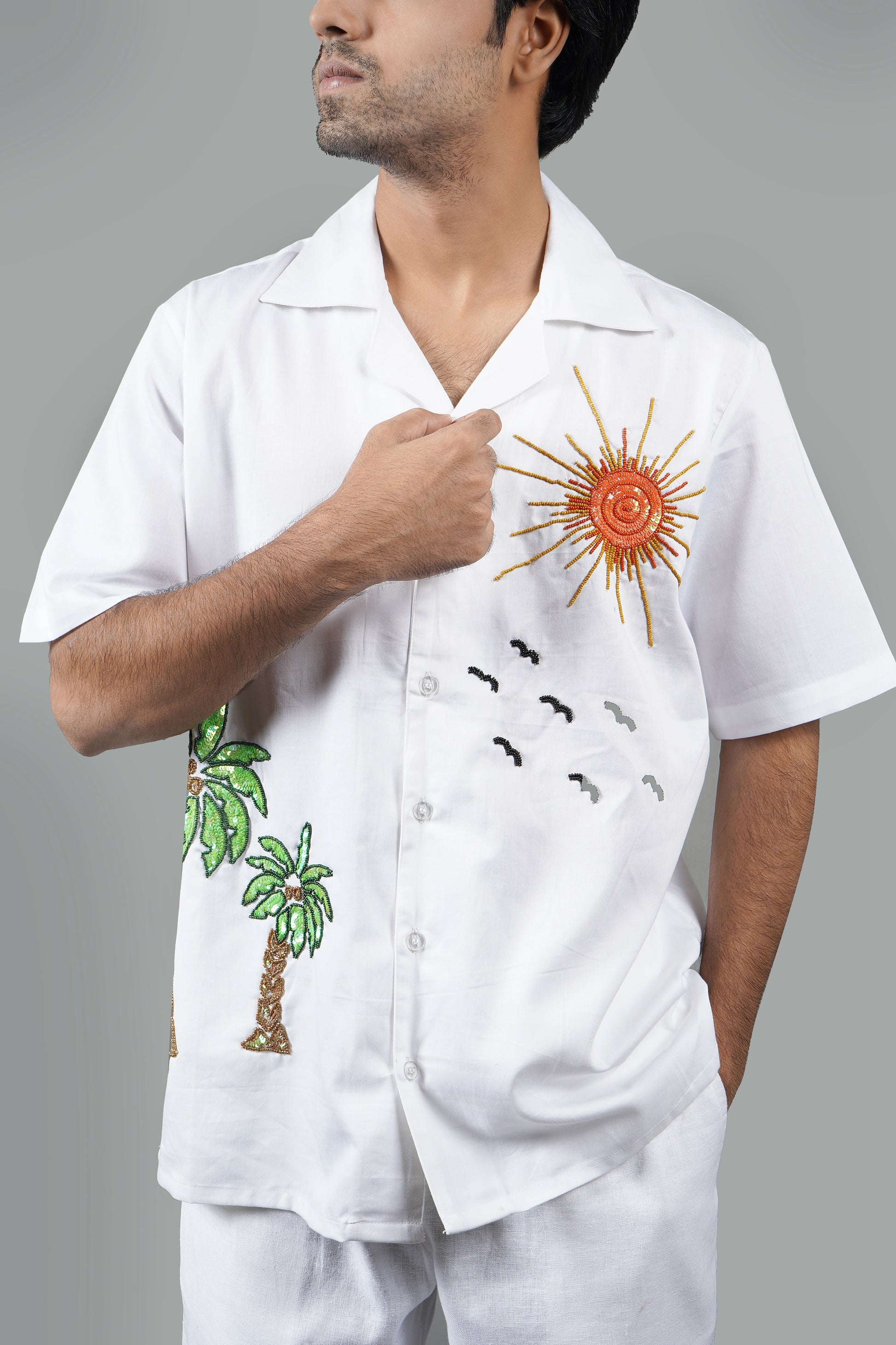 Handmade white cotton shirt with vibrant hand-embroidered tropical palm tree and sun design, luxury summer wear for men, unique artisanal embroidery.