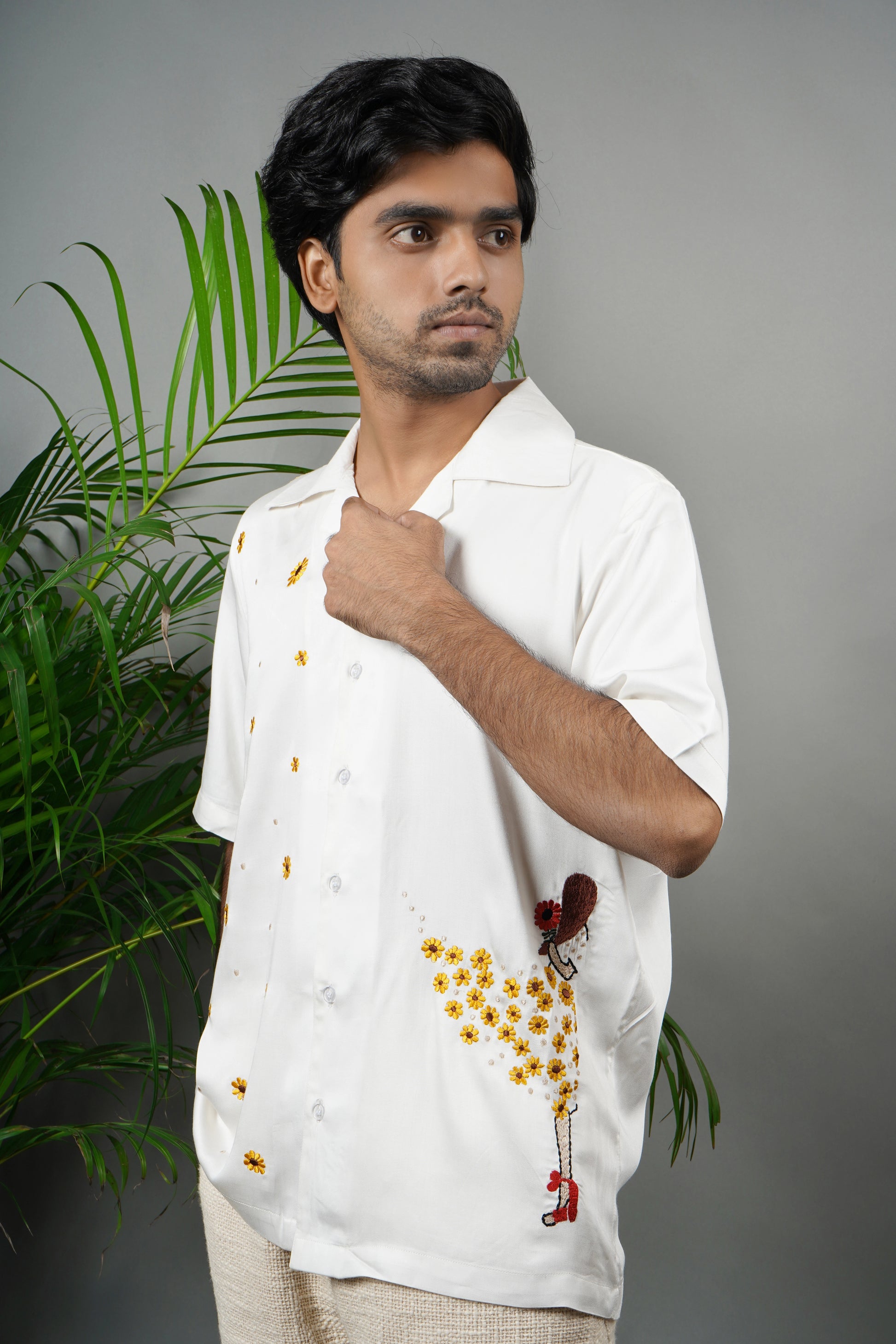 Handmade white modal shirt with delicate yellow floral embroidery, premium soft fabric, summer wear, luxury embroidered shirt for men.
