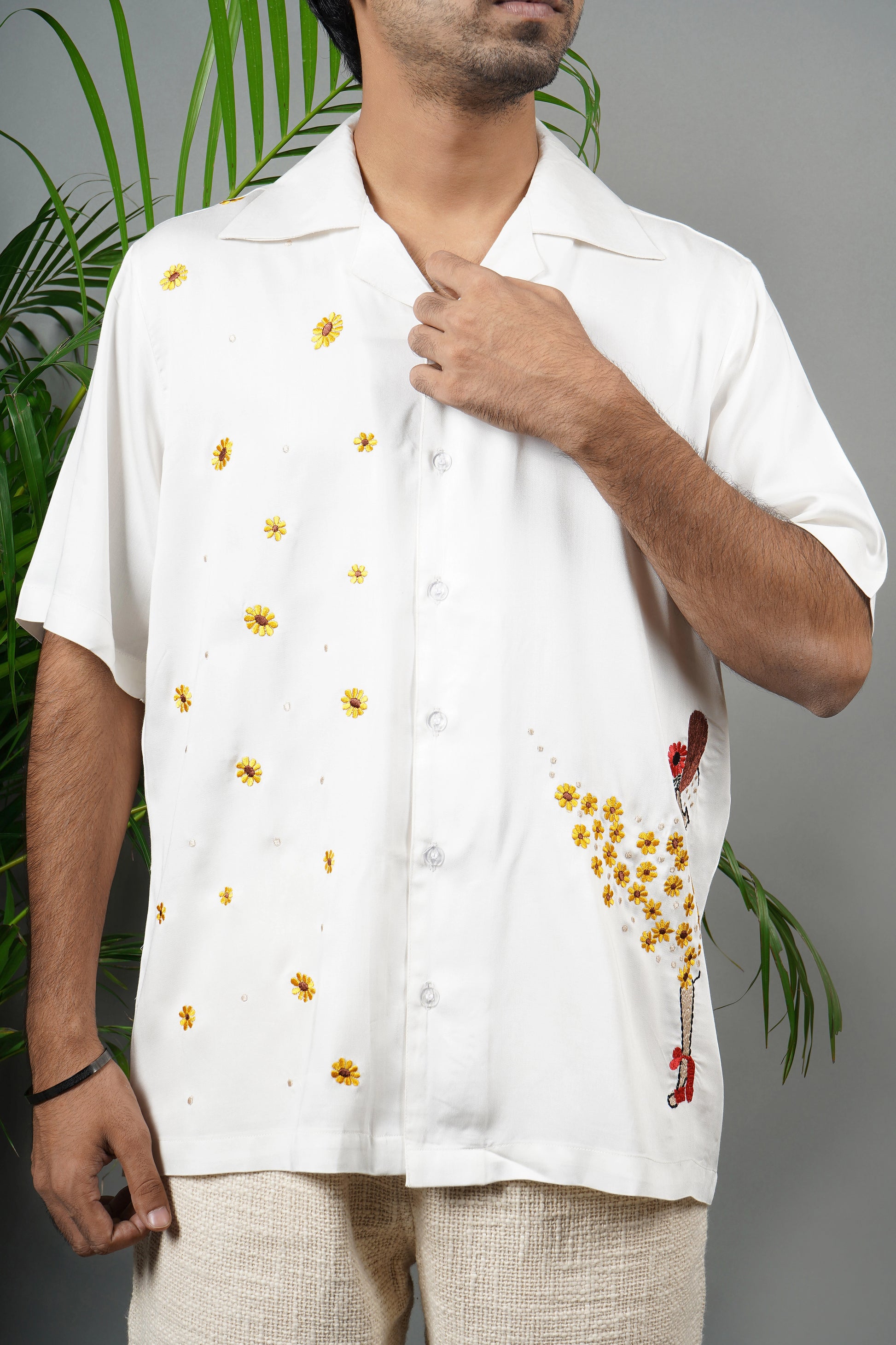 Handmade white modal shirt with delicate yellow floral embroidery, premium soft fabric, summer wear, luxury embroidered shirt for men.

