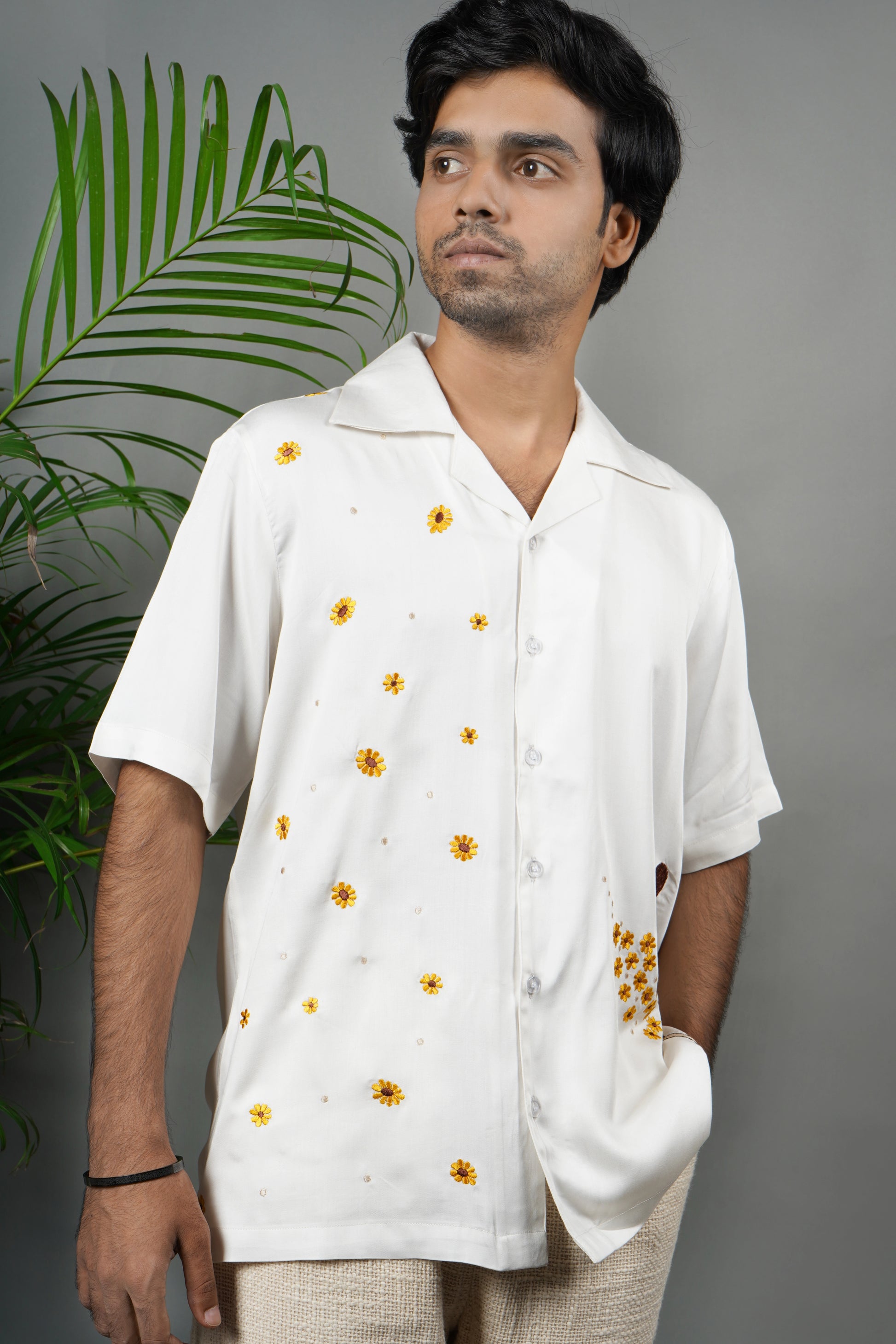 Handmade white modal shirt with delicate yellow floral embroidery, premium soft fabric, summer wear, luxury embroidered shirt for men.

