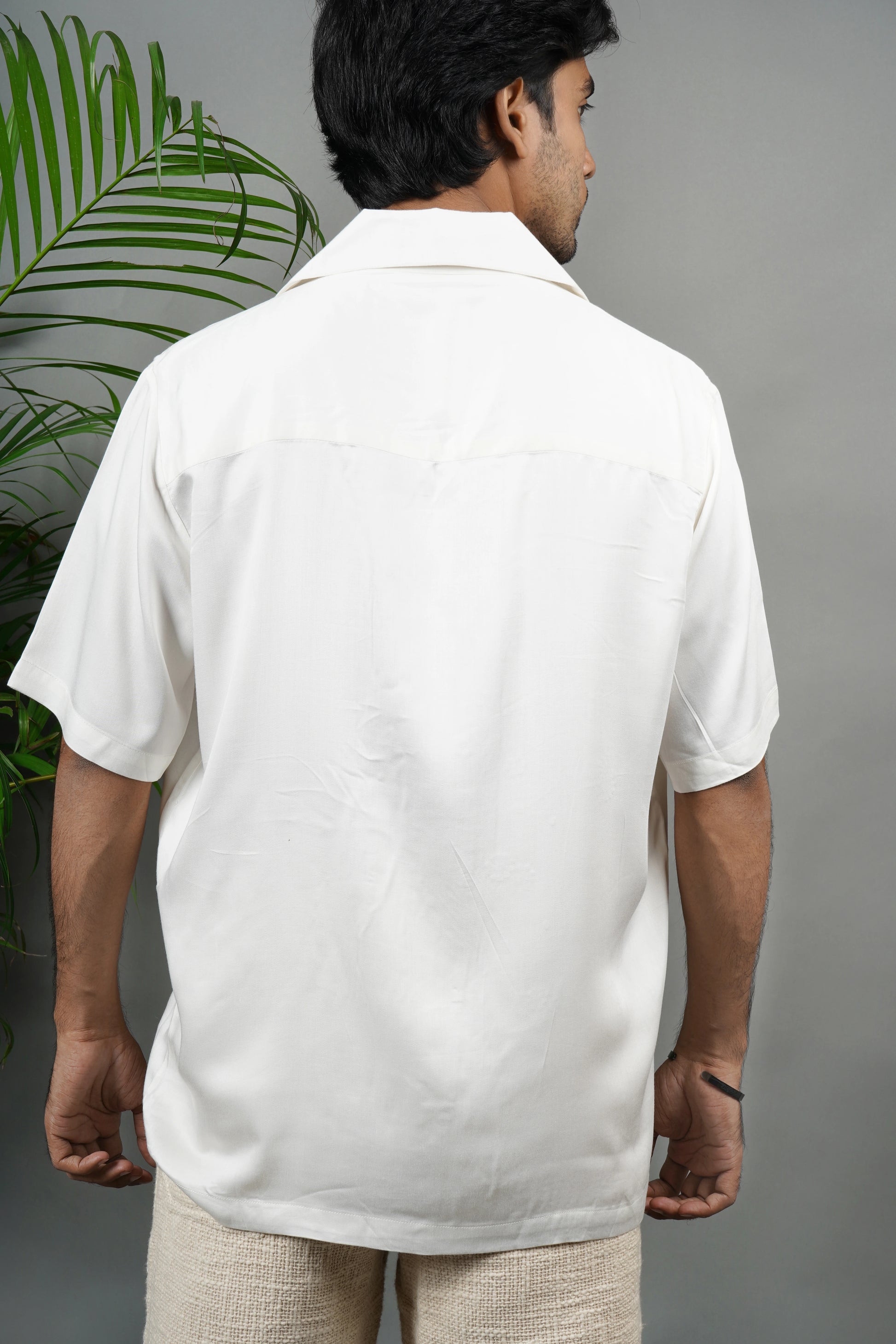 Handmade white modal shirt with delicate yellow floral embroidery, premium soft fabric, summer wear, luxury embroidered shirt for men.

