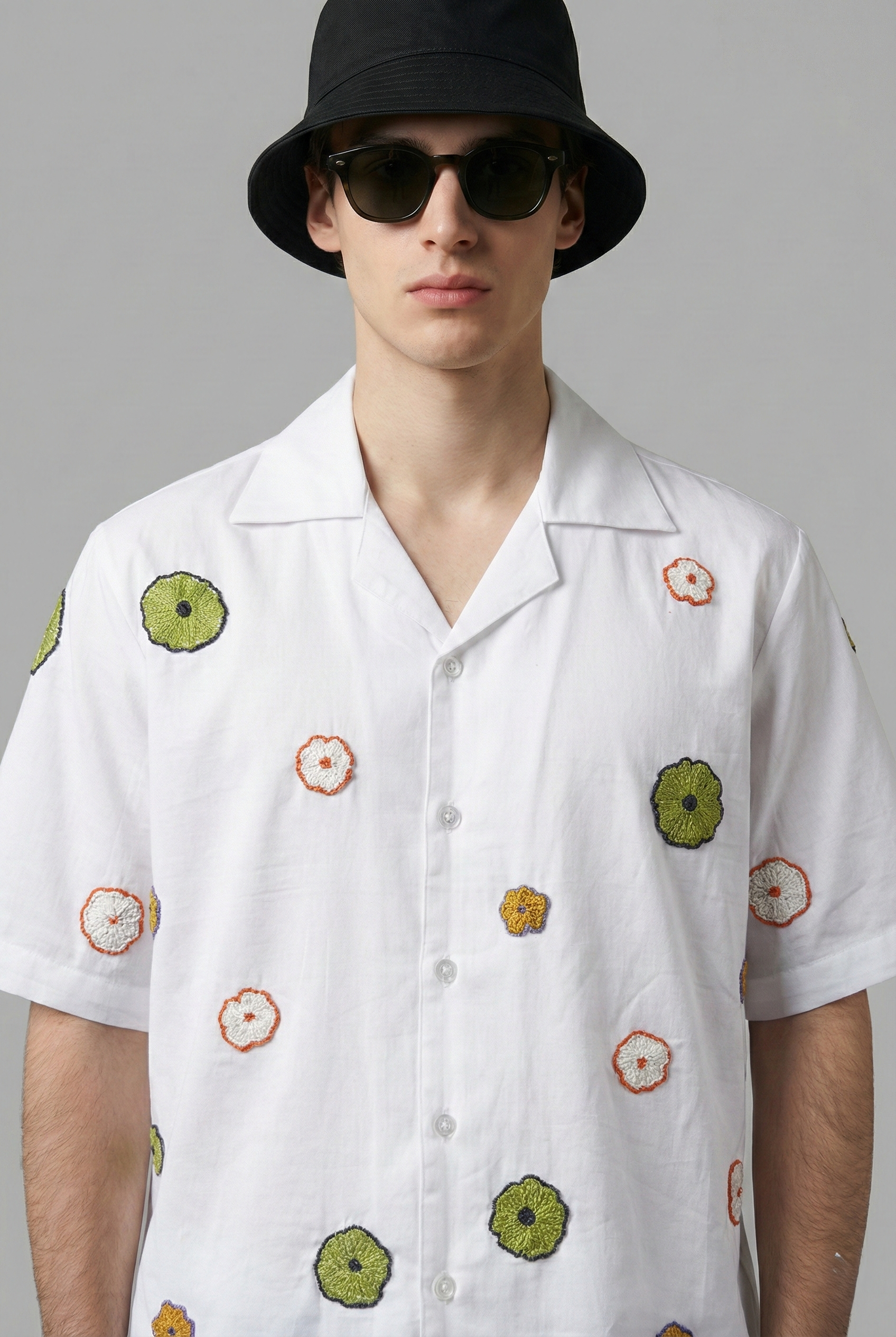 close up floral embroidery detail on white cotton cuban collar shirt