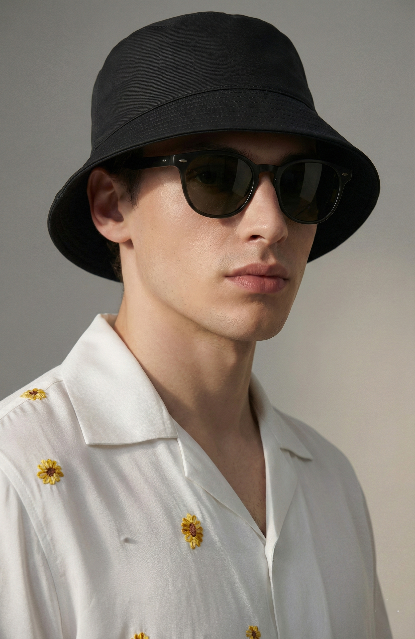 Close up of Cuban collar white shirt with small sunflower embroidery detail