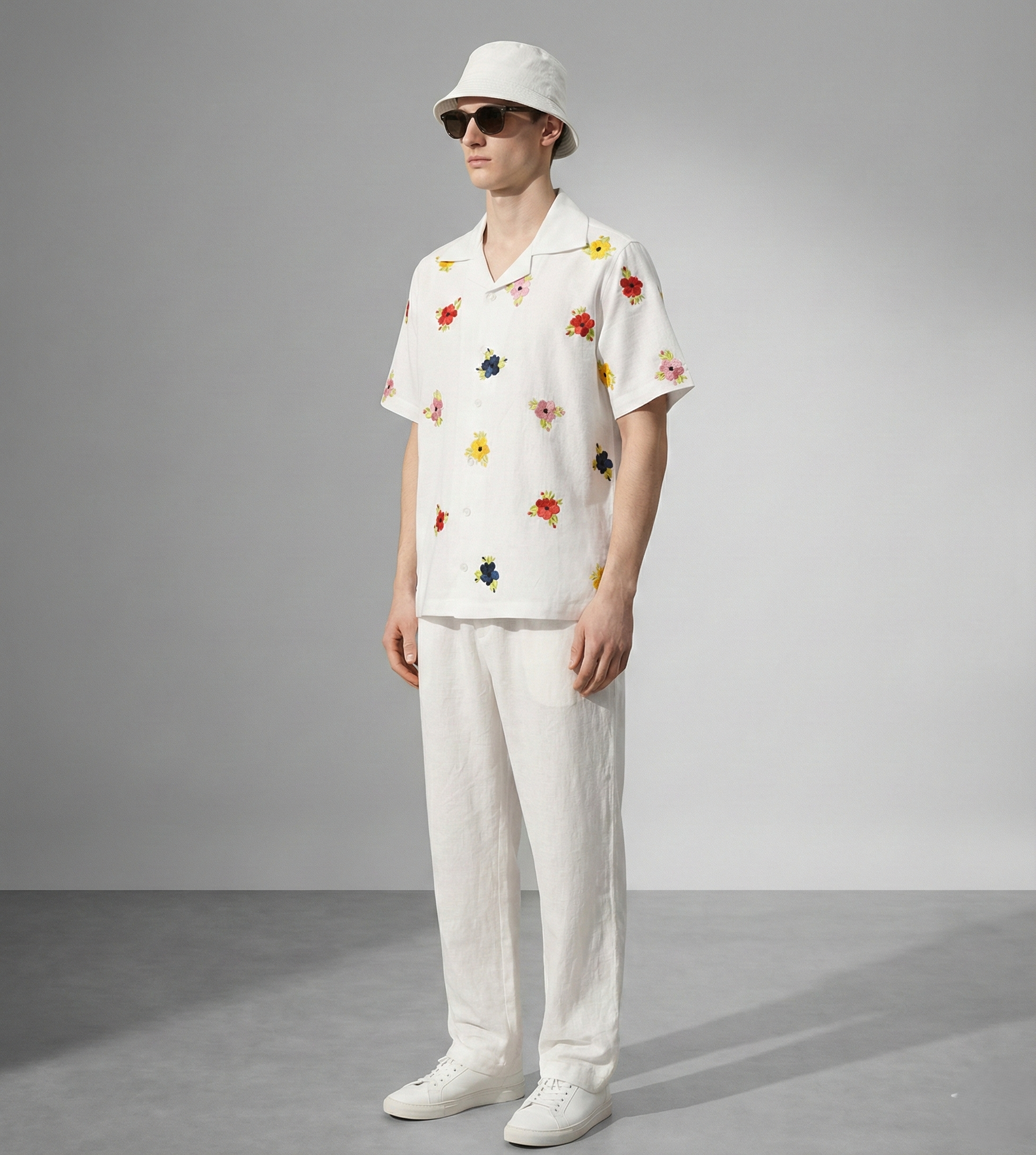 Side view of men's white Cuban collar cotton shirt with scattered floral embroidery, lightweight summer vacation shirt