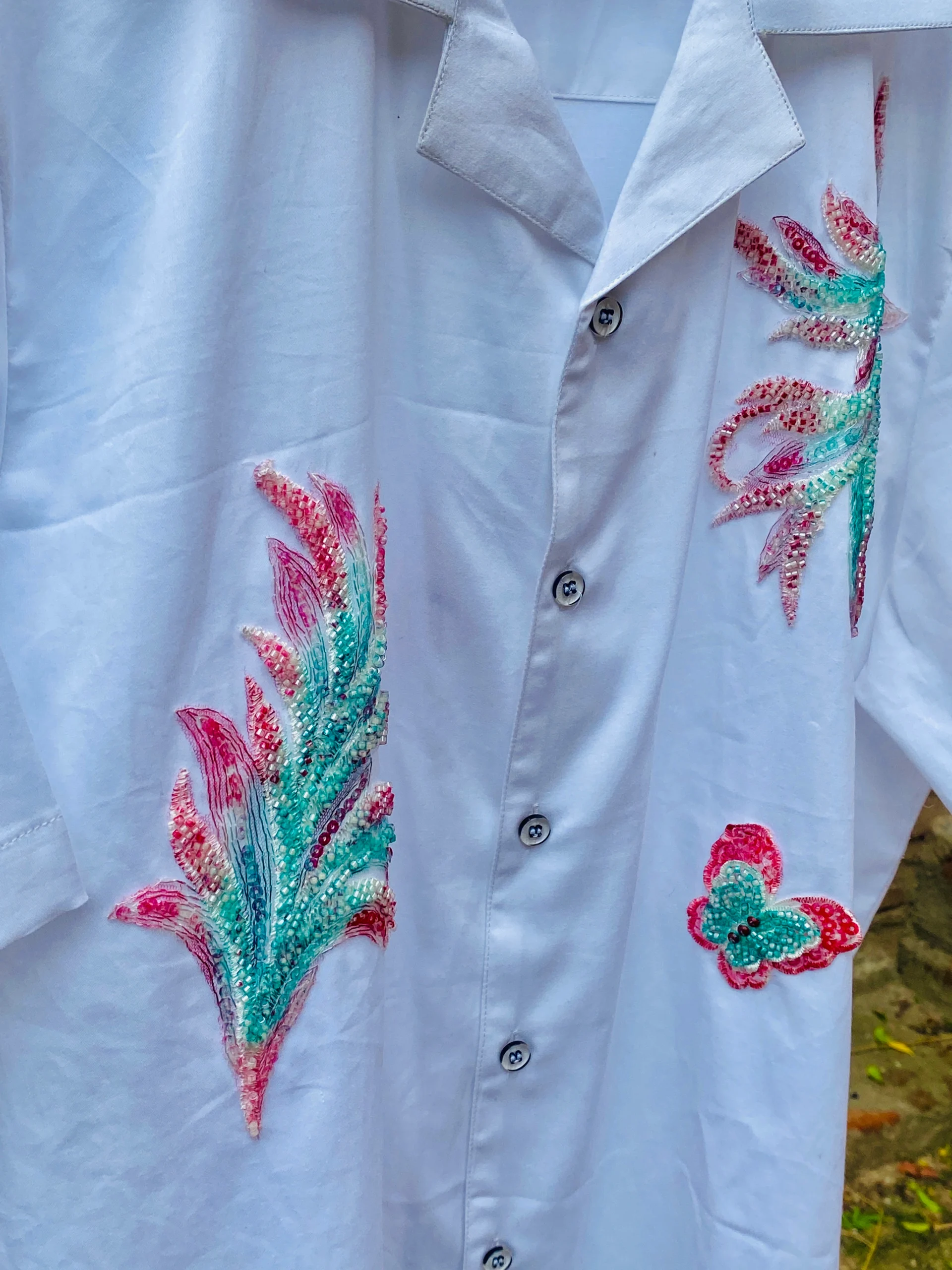 Close-up of Le Butterfly Hand Embroidery Shirt in 100% cotton with colorful butterflies and tropical leaf embroidery on a Cuban collar design.
