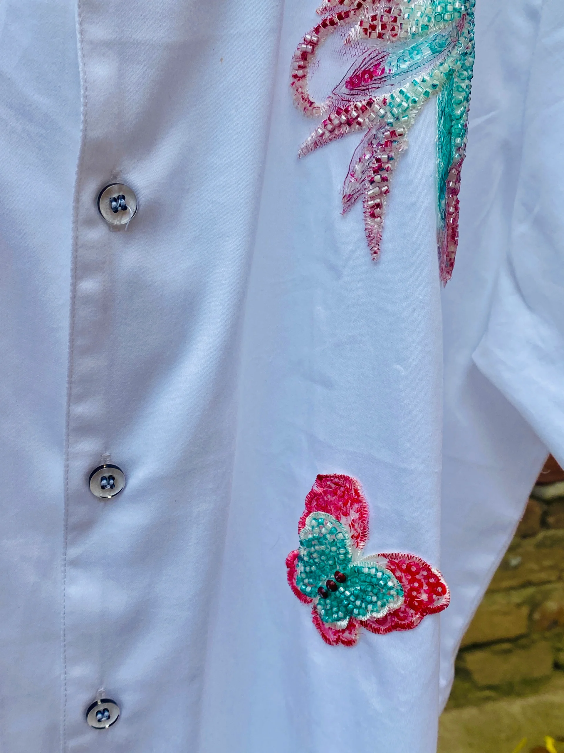 Close-up of Le Butterfly Hand Embroidery Shirt in 100% cotton with colorful butterflies and tropical leaf embroidery on a Cuban collar design.