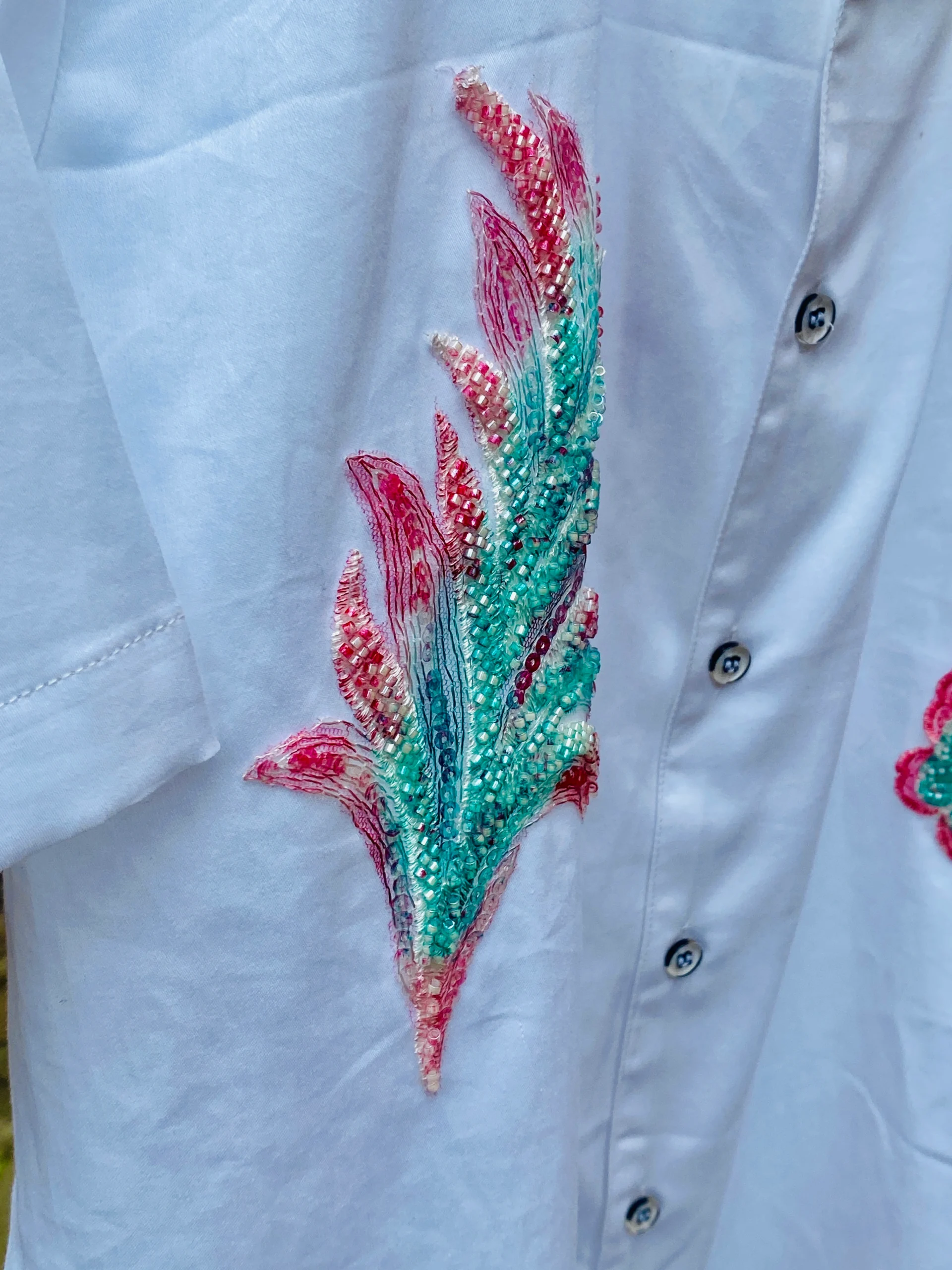 Close-up of Le Butterfly Hand Embroidery Shirt in 100% cotton with colorful butterflies and tropical leaf embroidery on a Cuban collar design.