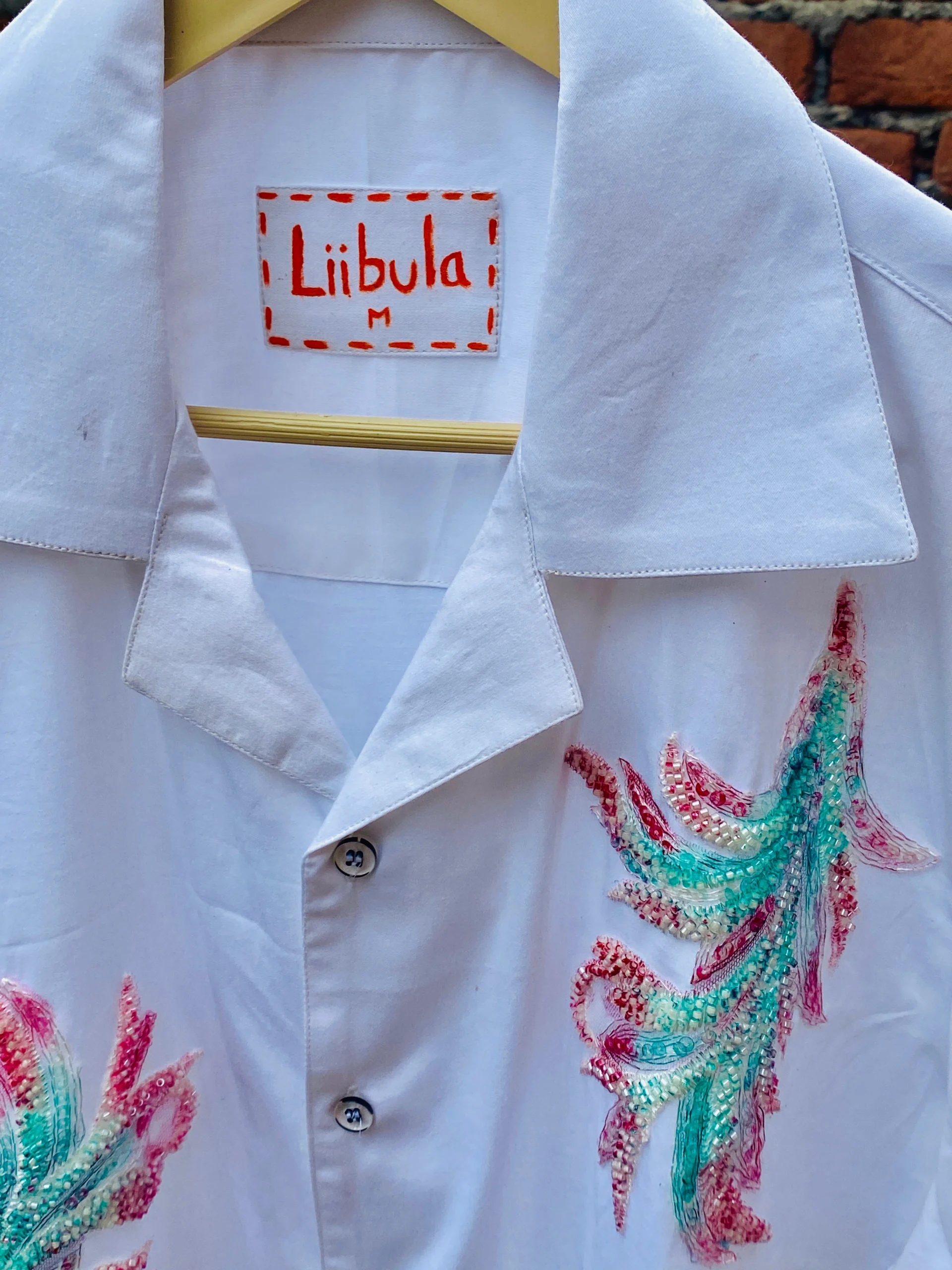 Close-up of Le Butterfly Hand Embroidery Shirt in 100% cotton with colorful butterflies and tropical leaf embroidery on a Cuban collar design.