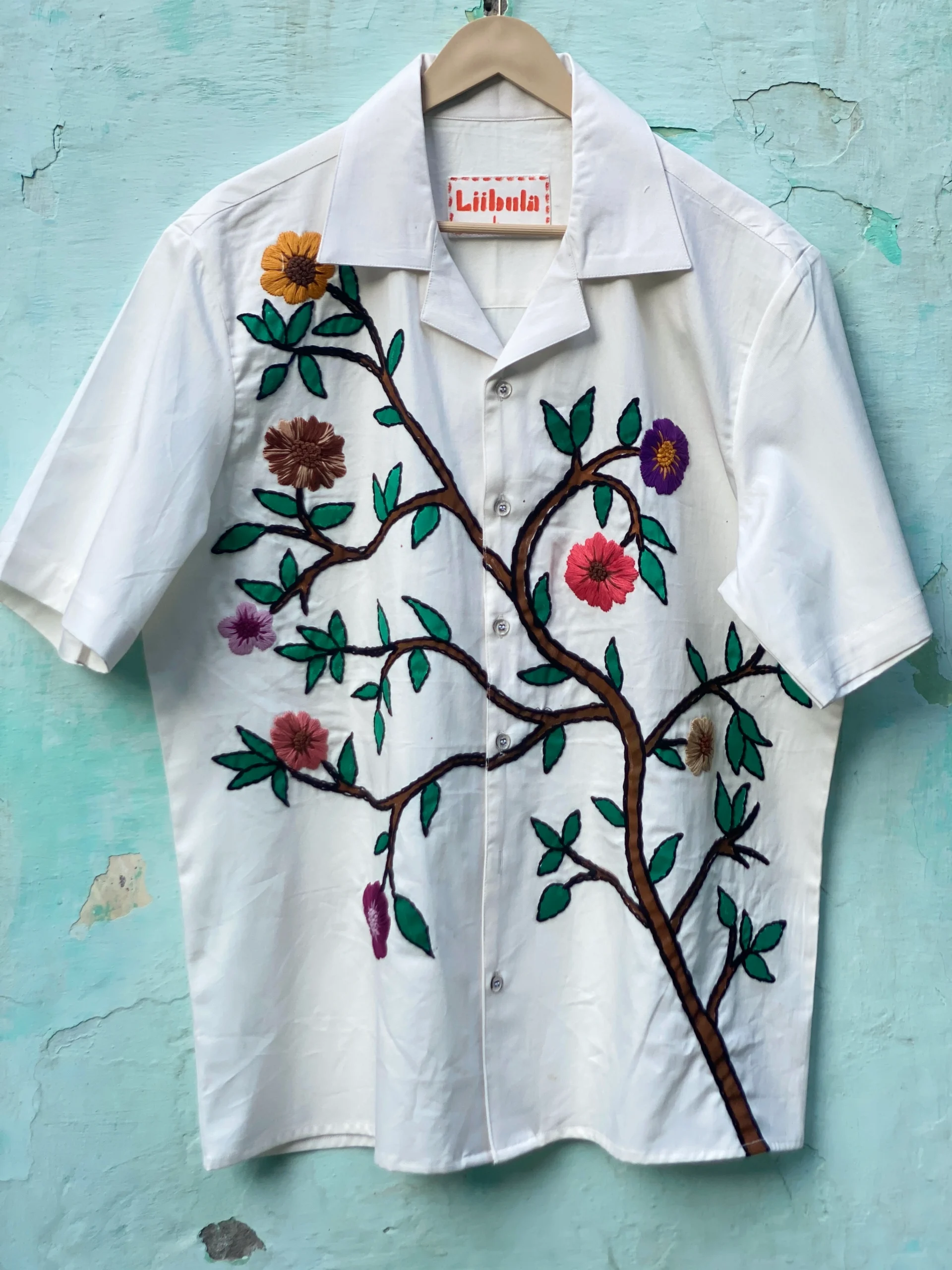 "Handmade cotton shirt with floral and tree design, crafted with hand embroidery, thread work, and fabric paint – limited edition Cuban collar shirt by Liibula"