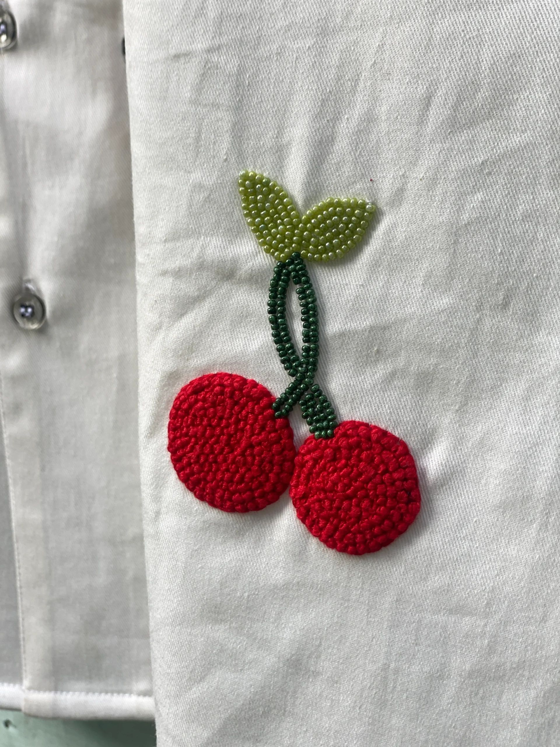 "Handmade cotton shirt with colorful hand embroidery, moti work, and fabric paint featuring motifs like bunny, umbrella girl, cherries, chicken, and carrot – limited edition Cuban collar shirt by Liibula"