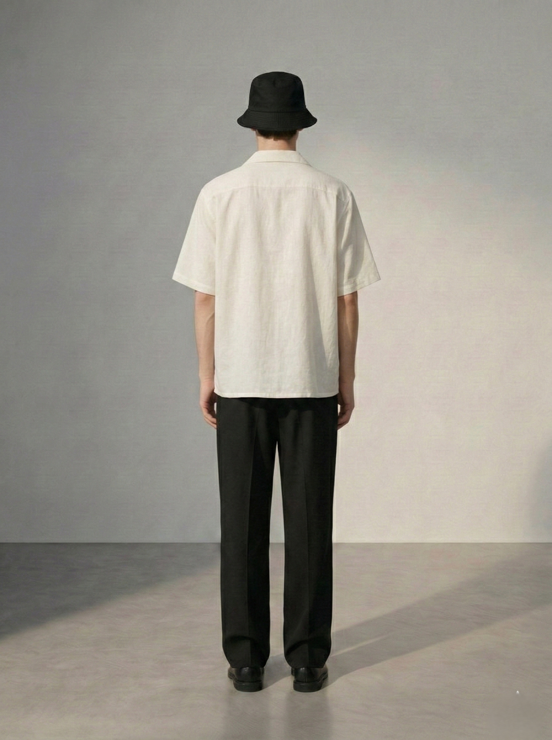Back view of mens white Cuban collar shirt with clean minimal design, lightweight linen shirt for summer vacation and resort wear