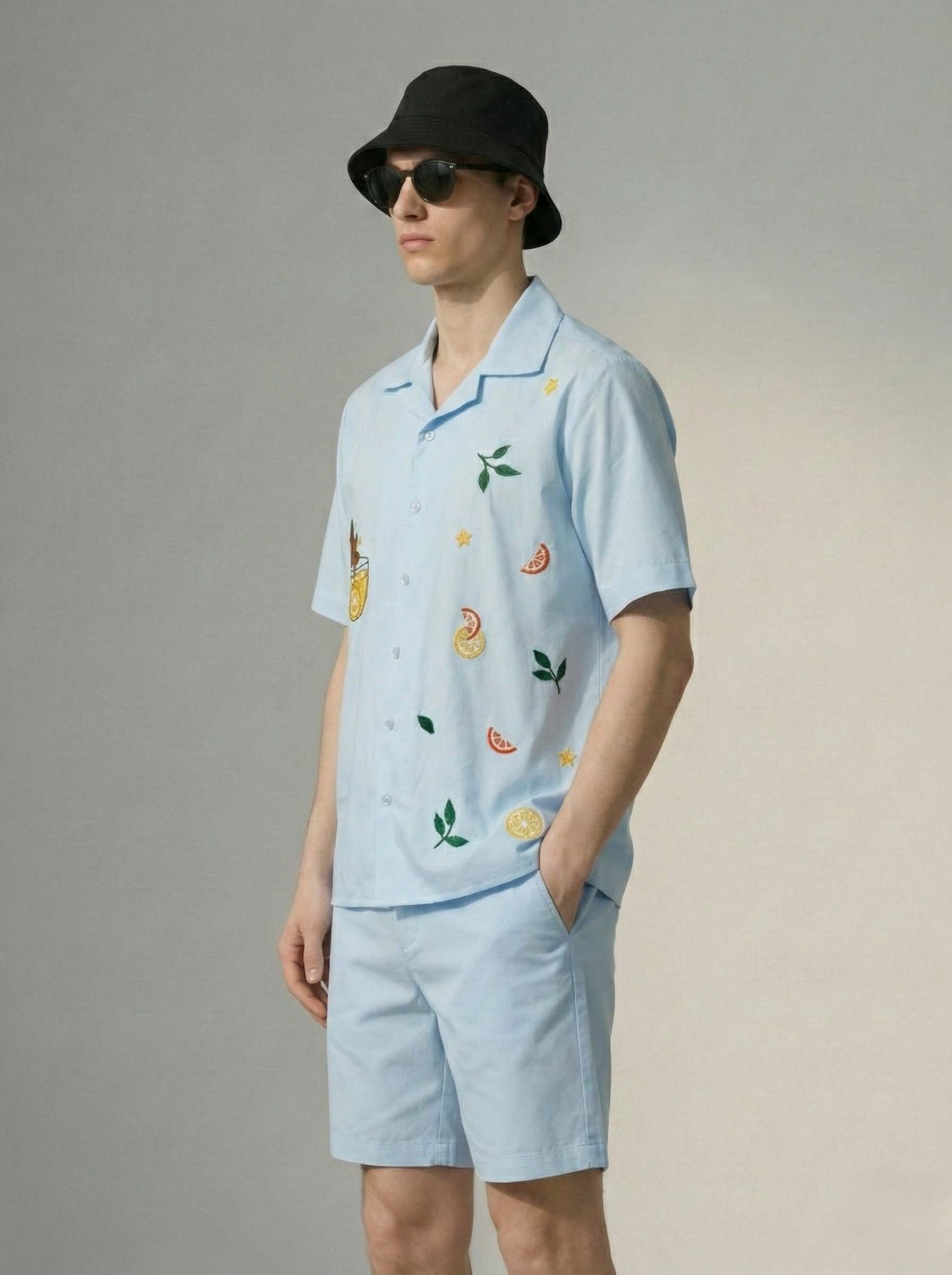 mens light blue cuban collar shirt side view with citrus fruit embroidery and cat artwork, breathable cotton summer outfit men USA