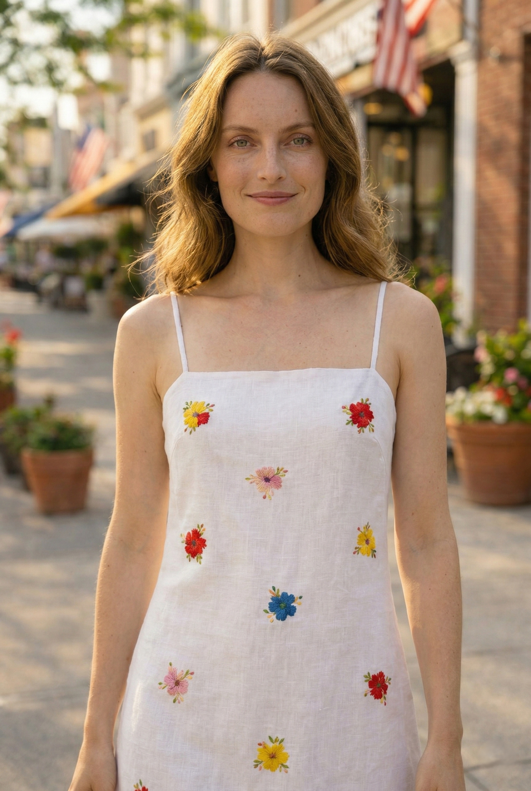 Close up colorful flower embroidery on white linen cotton dress