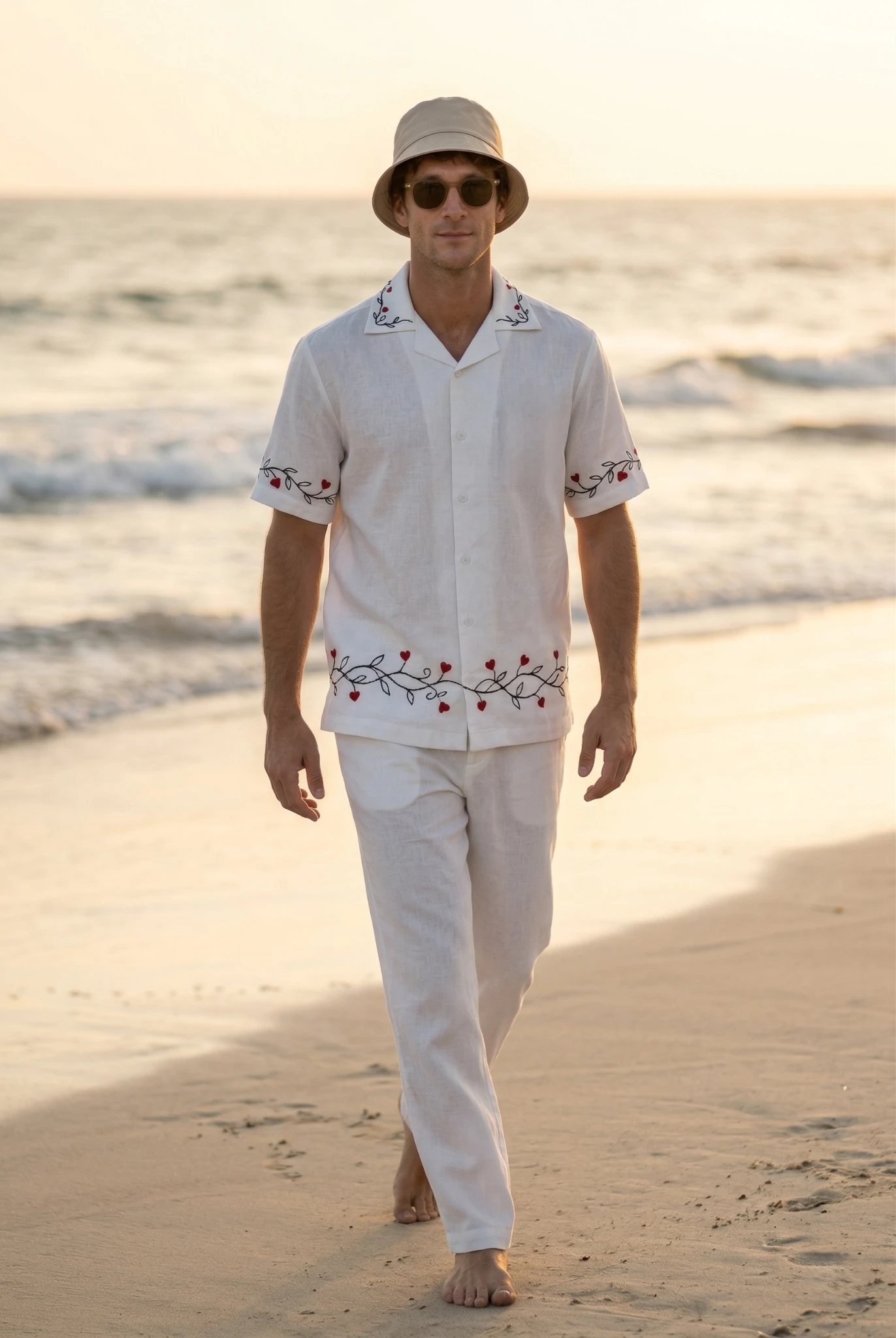 Men white linen embroidered shirt walking on beach at sunset, resort wear outfit with red heart embroidery, breathable summer clothing