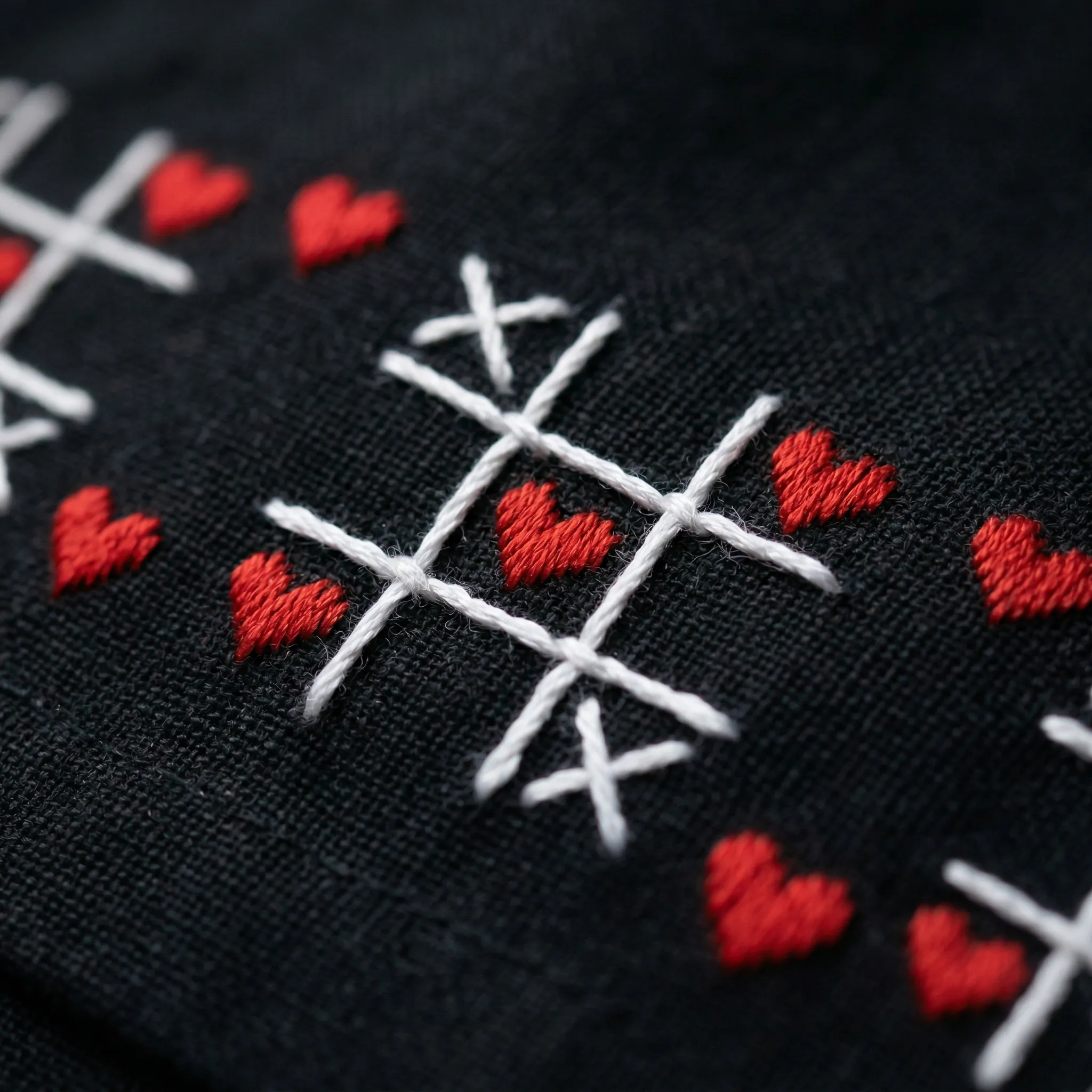 Close-up of red heart hand embroidery on black cotton shirt, detailed stitching luxury handmade mens fashion