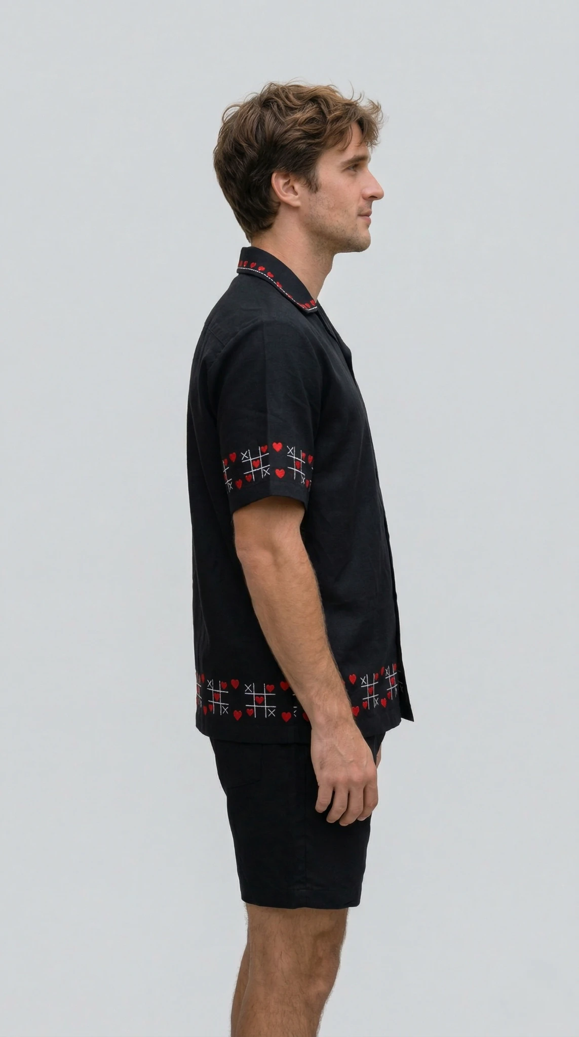 Side profile of black Cuban collar shirt with red heart embroidery, breathable cotton mens summer outfit luxury handmade clothing