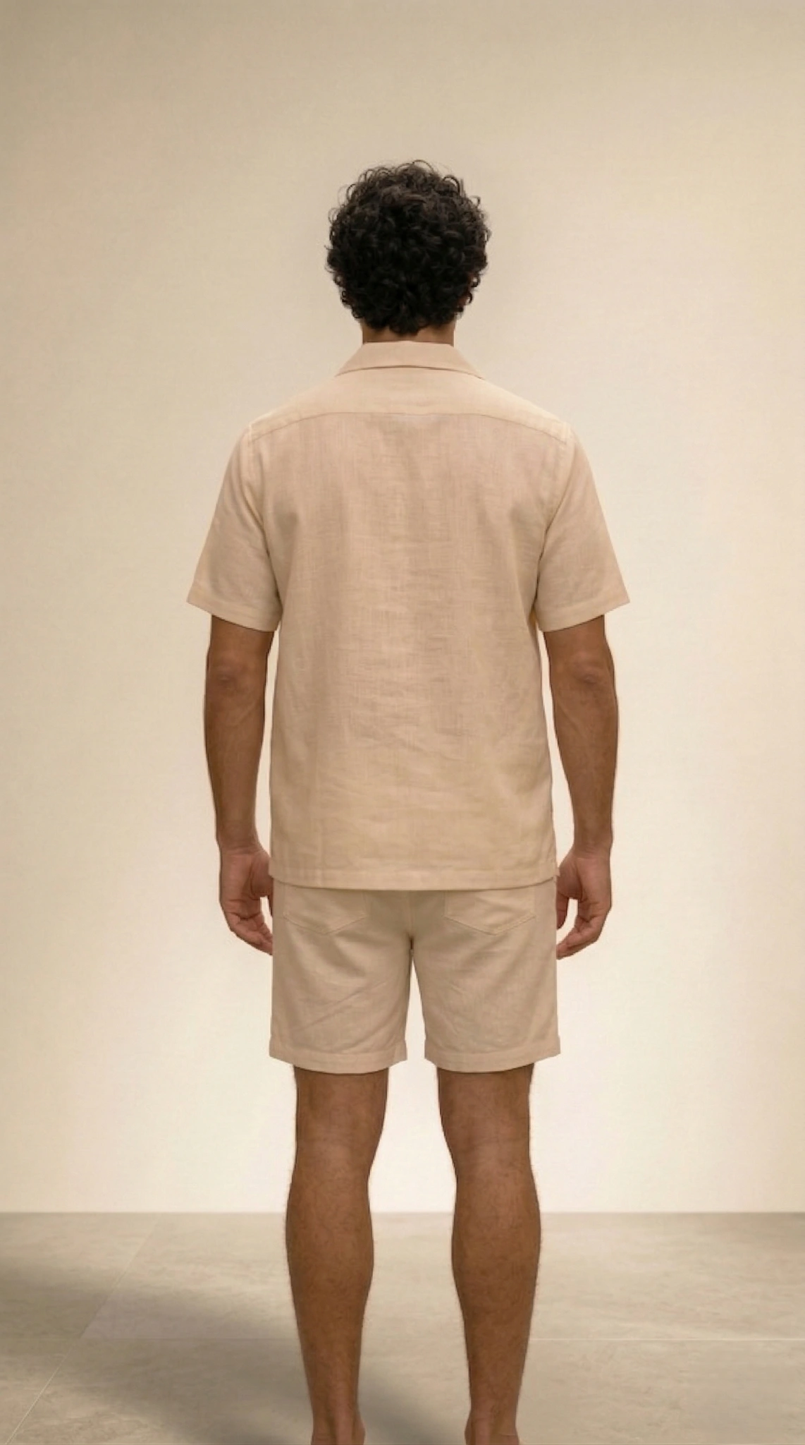 Back view men beige linen shirt minimal design relaxed fit summer outfit breathable fabric